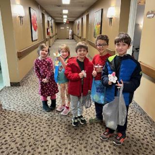 A joyful group of children enjoying their time together in a hotel hallway.