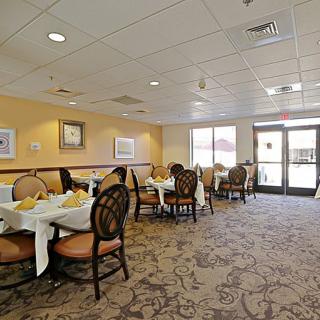 An elegant dining area with neatly arranged tables and chairs.
