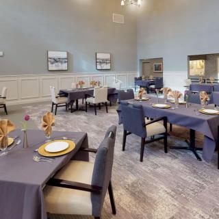 A neatly arranged dining area with tables set for guests.