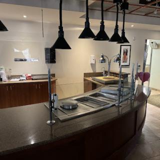 A modern buffet setup in a stylish kitchen with focused lighting.