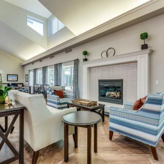 A modern living room with a fireplace and stylish furniture.