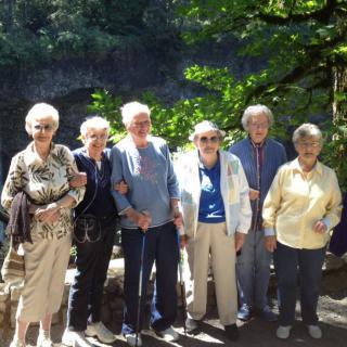 A group of seniors enjoying a sunny day together outdoors.