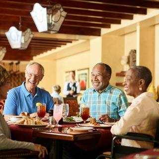 A group of people enjoying a meal together in a restaurant.