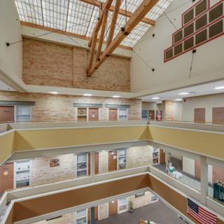 A modern atrium with multiple levels and a large skylight.