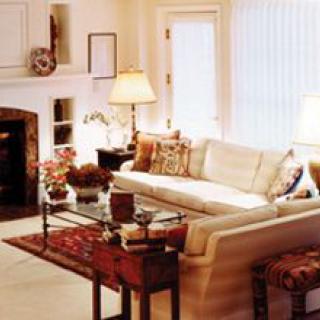 A cozy living room with a sofa, coffee table, and fireplace.