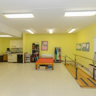 A bright and spacious physical therapy room designed for rehabilitation exercises.