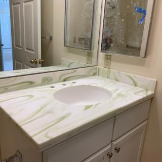 A clean and modern bathroom vanity with a marble-like countertop.
