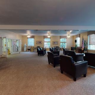 A spacious and inviting lounge area furnished with comfortable seating, illuminated by natural light.