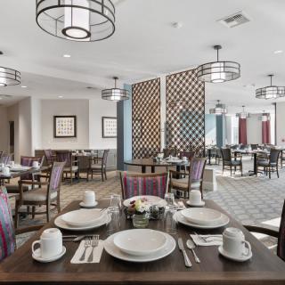 A modern restaurant dining area with neatly set tables and contemporary decor.