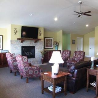 A cozy living room with a fireplace, television, and comfortable seating.
