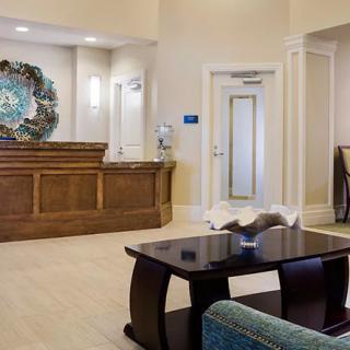 A well-lit lobby with comfortable seating and a reception desk.