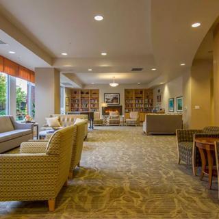 A spacious and cozy living room with modern decor, featuring ample seating and a warm ambiance.