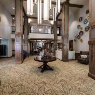Modern hotel lobby with stylish chandeliers and seating area.