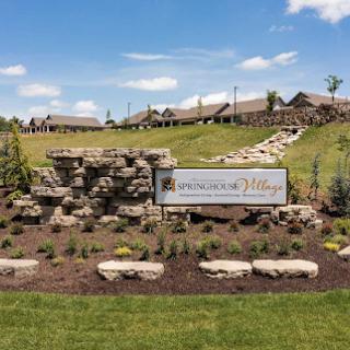 Entrance view showcasing the beautifully landscaped grounds and welcoming sign.