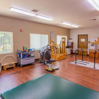 A well-equipped physical therapy room with various exercise machines and tools.