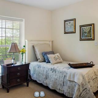 A cozy bedroom with a single bed and stylish decor.