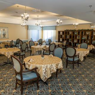 A beautifully arranged dining room with elegant tables and chairs.