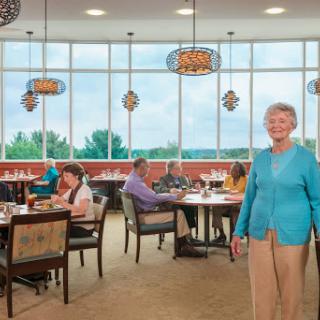 A lively dining area with patrons enjoying their meals in a bright and welcoming atmosphere.