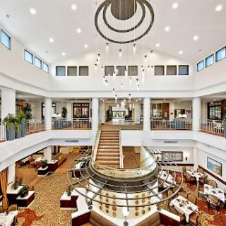 A stunning view of a modern restaurant lobby featuring elegant design elements and a striking chandelier.