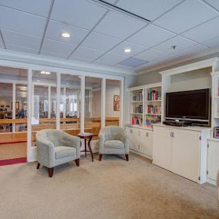 A cozy living room area featuring two chairs and a television unit, inviting relaxation and leisure.