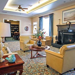A cozy living room with comfortable seating, a fireplace, and tasteful decor.