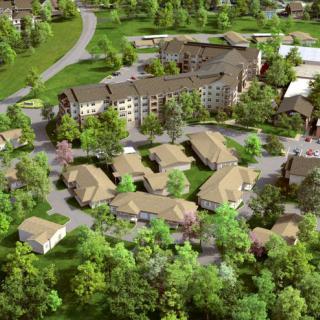 Aerial view of a residential area surrounded by lush greenery and trees.