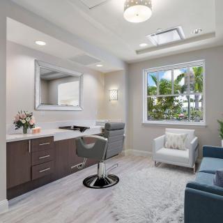 A modern, bright office space with comfortable seating and a large window overlooking greenery.