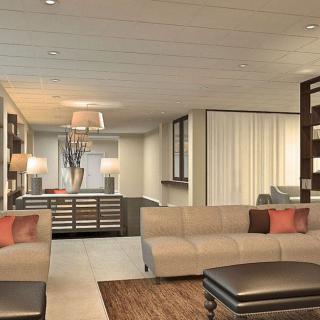Modern living room with stylish interior design featuring beige sofas and contemporary decor.