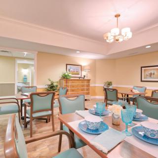 A well-arranged dining room with neatly set tables and elegant decor.