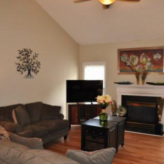 A cozy living room featuring a fireplace, television, and comfortable seating.