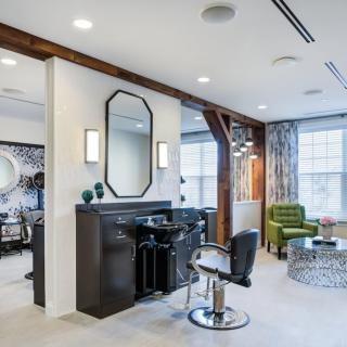 Modern salon interior with stylish furniture and bright lighting.