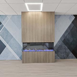 A modern interior with a sleek fireplace and geometric wall design.