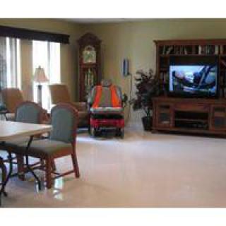 A cozy living room with a television and comfortable seating.