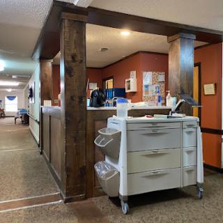A well-organized healthcare facility featuring a medical equipment cart in a welcoming environment.