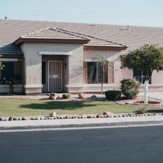 A cozy single-story house with a well-maintained front yard.