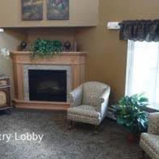 Cozy entry lobby with a fireplace and comfortable seating.