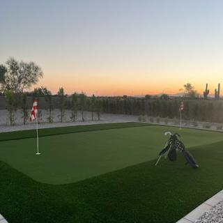 A serene putting green at sunset, perfect for practicing golf.