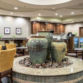 A cozy restaurant interior featuring decorative pots and a calming water fountain.