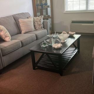 A cozy living room with a sofa and a coffee table.