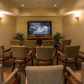 A cozy home theater setup with comfortable chairs and a large screen.