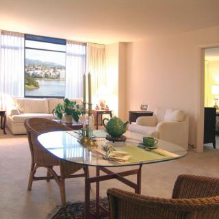 A spacious and bright living room with modern furniture and a cozy dining area.