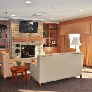 A cozy living room with a fireplace and comfortable seating arrangement.