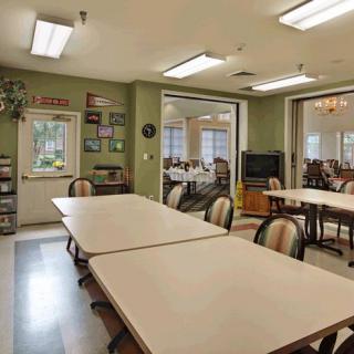 A community meeting room with tables and chairs arranged for gatherings.