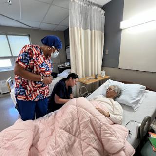 Healthcare professionals providing care to a hospitalized patient.