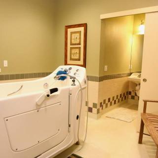 A well-lit bathroom features a walk-in bathtub designed for accessibility.