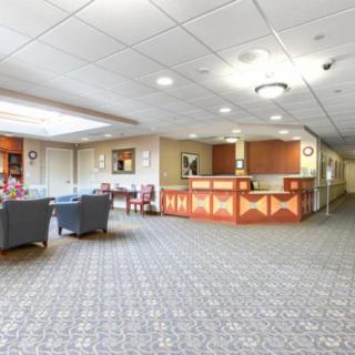 A spacious lobby with a reception desk and seating area.