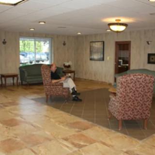 A quiet waiting area with comfortable seating and warm lighting.