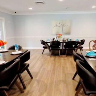 A beautifully set dining room with modern decor and elegant tableware.