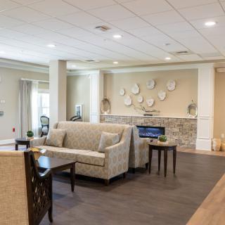 A modern living room with comfortable seating and a decorative fireplace.