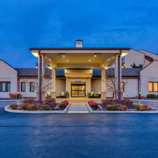 A well-lit hotel entrance with a modern architectural design at night.